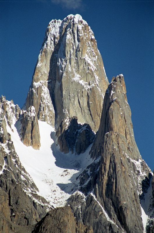 13 Uli Biaho Tower Close Up From Khoburtse Just After Sunrise Uli Biaho Tower shines in the early morning sun from Khoburtse. The first ascent of Uli Biaho Tower (6109m) was made on July 3, 1979 by John Roskelley, Kim Schimtz, Ron Kauk and Bill Forrest via the east face. One by one, each of us climbed to its broad top, soaked in the evenings warmth, cried a little, laughed a little, and, for just a few brief moments, forgot the cold, thirst, and danger below. - Stories Off The Wall by John Roskelley.